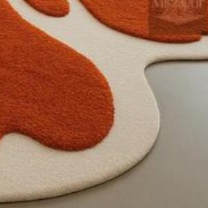 Funky 70s-inspired blob-shaped rug with high-low texture in open concept modern home interior.