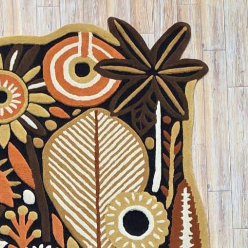 Decorative textile wall hanging crafted from wool, featuring folk botanical illustration in a modern organic composition.