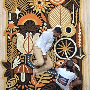 Statement textile wall art rug in organic shape, inspired by nature and folk illustration, perfect for boho and mid-century interiors.
