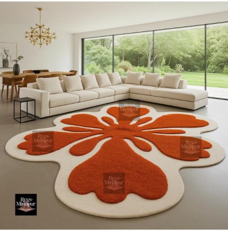 Modern groovy orange and cream flower-shaped rug in minimal living room with panoramic garden view.