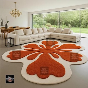 Modern groovy orange and cream flower-shaped rug in minimal living room with panoramic garden view.