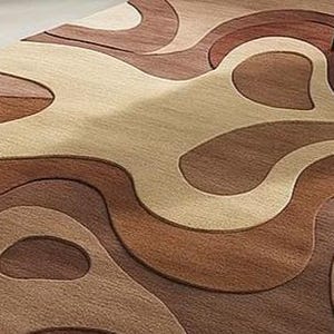 Sculptural high-low wool rug with abstract forms in camel, mocha, and ivory. A soft statement piece for American minimalist, boho, or modern interiors.