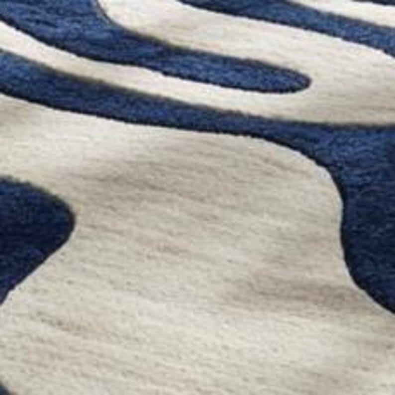 Contemporary navy and ivory wool rug featuring wave-inspired abstract design, hand-tufted by Rugs By Mirzapur. The thick pile and sculpted texture add depth and comfort. Perfect for modern interiors, this rug delivers luxury, warmth, and an organic artistic look.