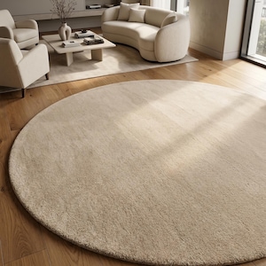 Sand beige hand tufted wool rug designed for upscale residential interiors featuring a rich plush texture and elegant monochromatic styling. Crafted from premium New Zealand wool, this custom area rug complements modern homes, luxury apartments, boutique hotels, designer residences, and carefully curated interior projects. Its versatile neutral palette integrates beautifully with contemporary furniture, architectural details, and natural décor elements.