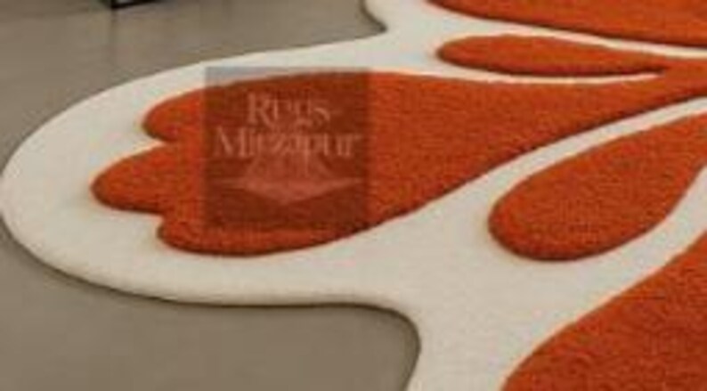 Statement shag rug in bright orange floral motif, ideal for maximalist or boho decor lovers.