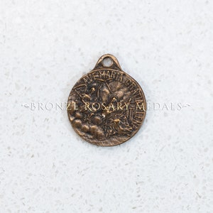 The Annunciation Medal depicts Archangel Gabriel, the Holy Spirit and Virgin Mary.  Ir reads, Ave Maria Gratia Plena. Replica Catholic Medal