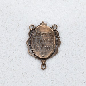 The back of the Divine Mercy center has the words "Jesus I Trust in You!" and is stamped "Italy"