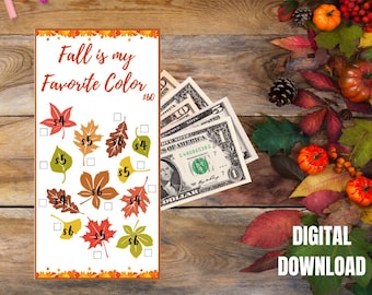 Op de afbeelding: Een printbare spaaruitdaging met bladerillustraties en de tekst "Fall is my Favorite Color". De afbeelding bevat Amerikaanse valuta, herfstbladeren en gekleurde stiften op een houten achtergrond.