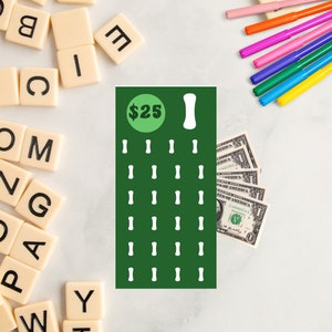 May include: A green and white bingo card with the number $25 in a green circle at the top. The card has 25 spaces with white bones in each space.