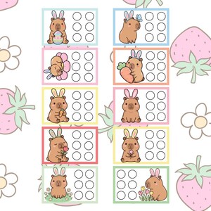 May include: A collection of colorful, illustrated cards featuring adorable capybaras dressed as bunnies, holding Easter eggs, carrots, and flowers. Each card has a set of blank circles, set against a background of strawberries and flowers.