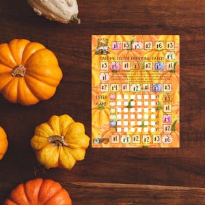 May include: A printable game board with an orange and yellow pumpkin theme. The game is called "Take Me to the Pumpkin Patch". The board has a grid with numbers and dollar signs. There is an extra game section with a grid of smaller squares.