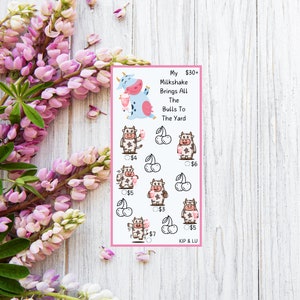 May include: A pink and white printable sticker sheet with a cartoon cow holding a milkshake. The text reads "My Milkshake Brings All The Bulls To The Yard". There are 8 cows with different prices listed below each cow.