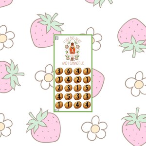 May include: A green and white card with the text "I Like Big Nuts And I Cannot Lie" and a nutcracker illustration. The card has a grid of numbers and is set against a white background with pink strawberries and white flowers.