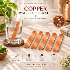 Pode incluir: Um conjunto de cinco tiras purificadoras de água de cobre retangulares com bordas arredondadas. Uma tira está submersa num copo de água, enquanto quatro outras estão planas. O texto diz BY JAIDURGAHANDICRAFTS, COPPER WATER PURIFIER STRIP, SET OF 5 PCS.