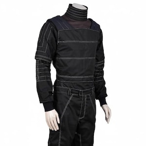 May include: A black long-sleeved top and matching pants set featuring a high mock neck collar. The garment is detailed with prominent white topstitching that creates horizontal lines across the chest, sleeves, and legs, with reinforced shoulder panels.