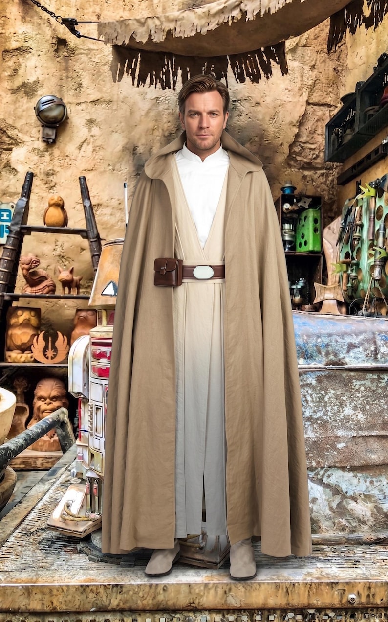 May include: A person wearing a tan cloak and tunic, with a brown belt and pouch. The outfit is reminiscent of a character from a science fiction film. The background features a rustic, themed environment with various props.