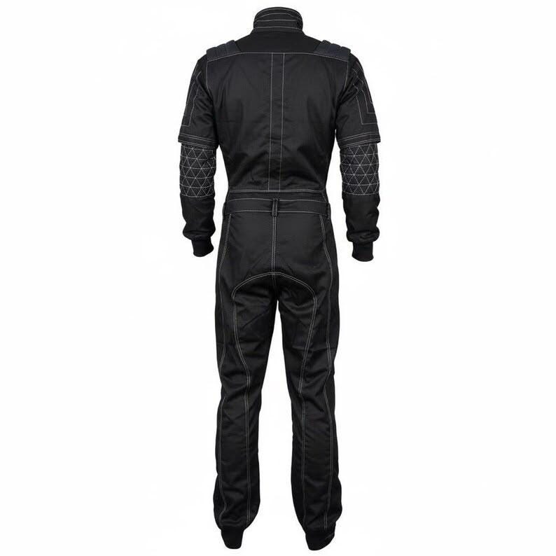 May include: A black jumpsuit featuring long sleeves and full-length trousers with prominent white contrast stitching throughout. The garment includes a high collar, a fitted waist, and geometric triangular patterns stitched onto the upper sleeves.