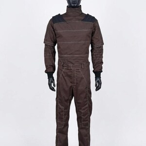 May include: Brown jumpsuit with a high collar, black shoulder accents, and white stitching details. The long-sleeved garment features a fitted waist and is displayed on a mannequin. The jumpsuit has black gloves and is designed for cosplay or costume use.