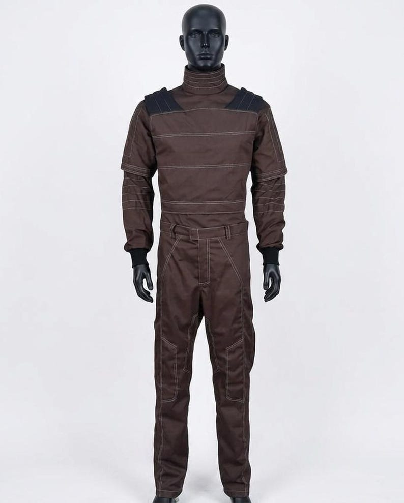 May include: Brown jumpsuit with a high collar, black shoulder accents, and white stitching details. The long-sleeved garment features a fitted waist and is displayed on a mannequin. The jumpsuit has black gloves and is designed for cosplay or costume use.