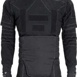May include: Black tactical uniform with white stitching details. The outfit includes a high-collared jacket, pants, and fingerless gloves. The jacket features reinforced panels and multiple Velcro closures. The overall design suggests a focus on protection and functionality.