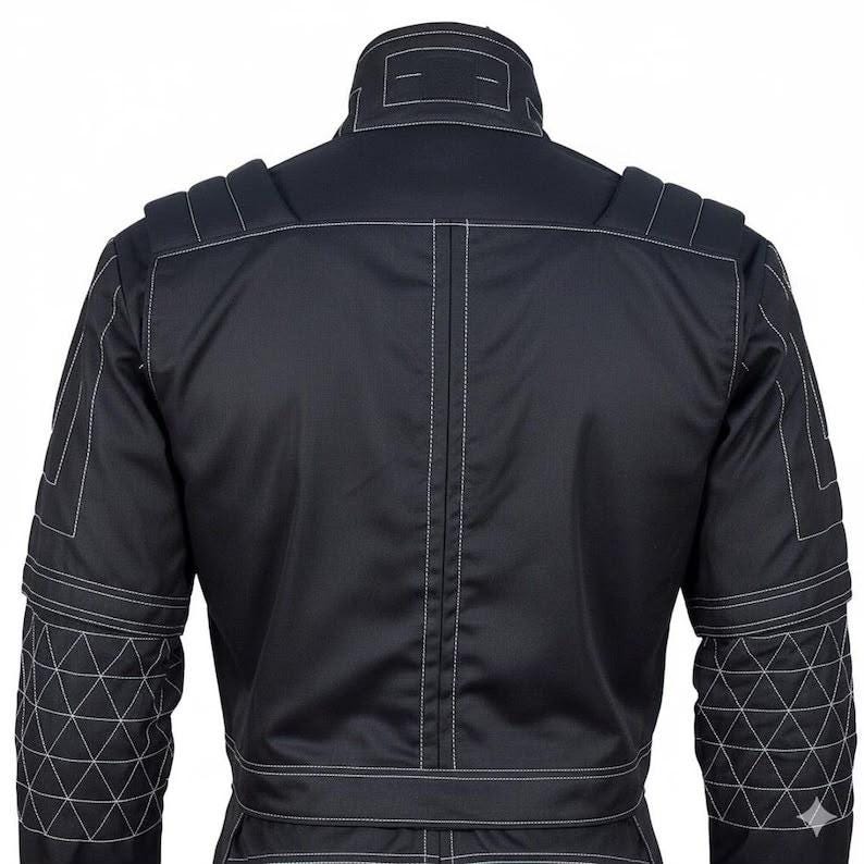 May include: A black jacket featuring a high collar, structured shoulder panels, and long sleeves with a white triangular grid pattern on the lower arms. The garment is accented with prominent white topstitching along the seams and back panel.