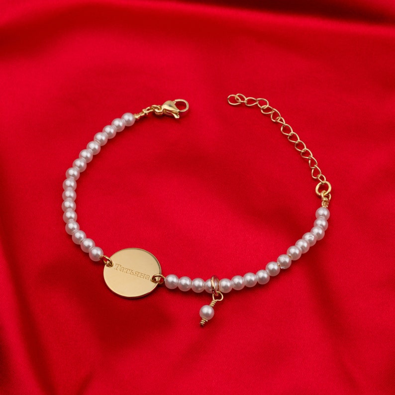 a bracelet with a gold disc and pearls