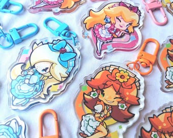 May include: A collection of clear acrylic keychains featuring chibi-style characters with colorful hair and outfits. Each charm includes a plastic lobster clasp in shades of pink, blue, or orange, and displays vibrant graphic illustrations of anime-inspired figures.