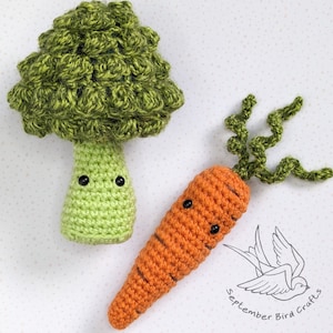 May include: A crocheted green broccoli and a crocheted orange carrot with black eyes. The carrot has a green leafy top. The image includes the text "September Bird Crafts".