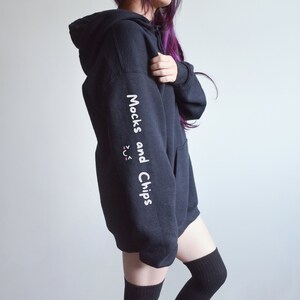 May include: Black hooded sweatshirt with the text "Mocks and Chips" printed on the left sleeve in white.