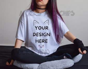 May include: A white t-shirt with a black cat ear design and the text "YOUR DESIGN HERE" in black. The shirt is being worn by a person with long purple hair.