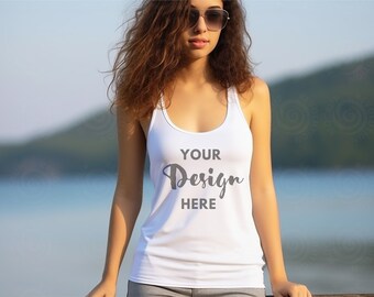 Puede incluir: Un top blanco de tirantes con el texto "YOUR Design HERE" impreso en la parte delantera. El top lo lleva una persona con el pelo largo y castaño y gafas de sol.