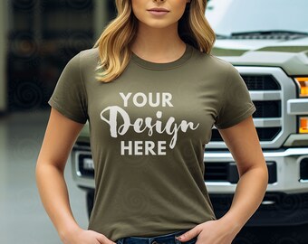 May include: A woman wearing a green t-shirt with the text "YOUR Design HERE" printed on the front. She is standing in front of a green truck.