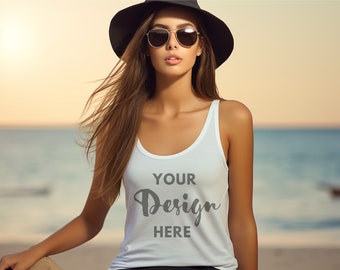 May include: A woman wearing a white tank top with the text "YOUR Design HERE" on the front. She is wearing a black hat and sunglasses and is standing on a beach.