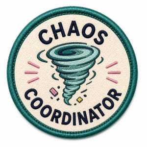 May include: Embroidered patch with the words "CHAOS COORDINATOR" in navy blue, surrounding a teal tornado graphic. The patch has a cream-colored background with a teal border and pink and yellow accents.