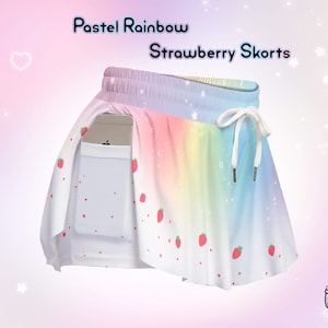 May include: Pastel rainbow strawberry skorts. These skorts feature a rainbow gradient design with a white drawstring and a pocket. The skorts are decorated with red strawberry graphics. The text "Pastel Rainbow Strawberry Skorts" is at the top.