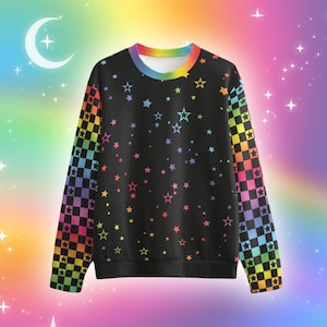 May include: A black long-sleeve sweatshirt featuring a rainbow-coloured checkered pattern on the sleeves and a scattered print of multi-coloured stars across the front. The crew neckline is trimmed with a vibrant rainbow gradient band.