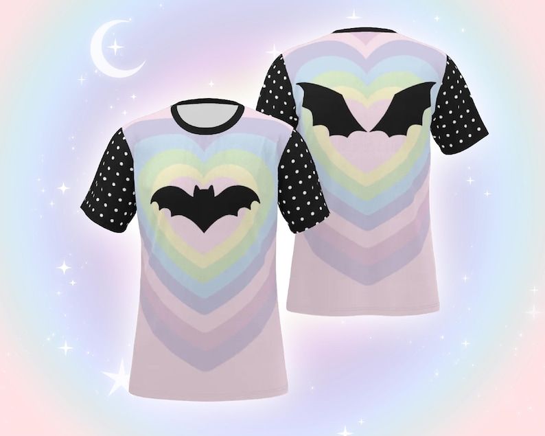 May include: Two t-shirts with a pastel rainbow heart design and a black bat silhouette in the center. The sleeves are black with white polka dots. The shirts have a black collar.