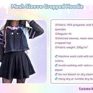 May include: Black cropped hoodie with mesh sleeves, featuring a cat design. The hoodie is paired with a black pleated skirt. The image includes the text "Mesh Sleeve Cropped Hoodie".