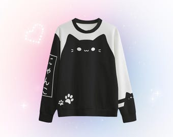 May include: Black and white sweatshirt with a cartoon cat design and the Japanese text "にゃんこ" on the sleeve.