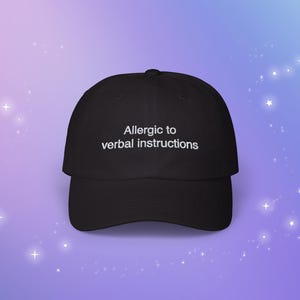 May include: A black baseball cap with white text that reads "Allergic to verbal instructions".