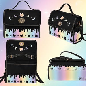 May include: Black satchel bag with a rainbow drip design and cat paw prints. The bag has a gold clasp and a removable shoulder strap. The bag is closed and the inside is not visible.