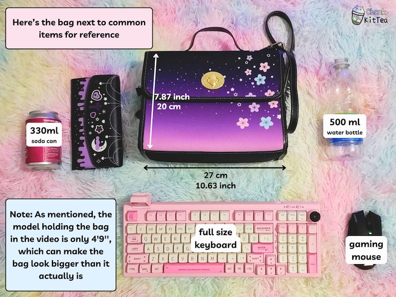 May include: A purple and black shoulder bag with a floral print and a gold clasp. The bag is next to a 330 ml soda can, a wallet, a full-size keyboard, a gaming mouse, and a 500 ml water bottle. The bag measures 7.87 inches tall and 10.63 inches wide.