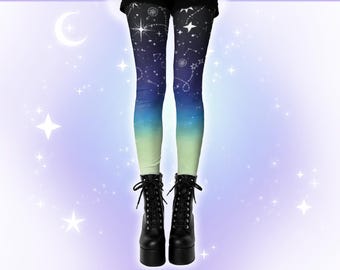 May include: Leggings with a celestial design featuring constellations and stars in white against a gradient background of dark blue, light blue, and green. The leggings are paired with black platform boots with laces.