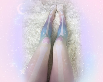May include: Opaque tights featuring a pastel gradient of pink, yellow, and blue. The design displays a white skeletal bone print running down the legs, accented with heart-shaped knee caps and small star motifs scattered along the sides.
