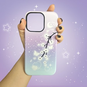 A phone case with a  kawaii design -
branch of glowy white cherry blossom branch with sparkles, the background is pastel gradient pink - lilac - blue