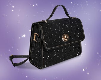 May include: A black satchel bag with a white star pattern. The bag has a gold clasp and a long adjustable strap.