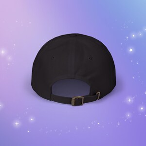 May include: Black baseball cap with a brown adjustable strap in the back.