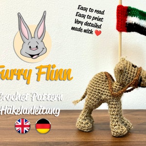 May include: Crochet pattern for a camel with a flag on its back. The pattern is available in English and German. The pattern is easy to read and print, and is very detailed. The pattern is made with love.