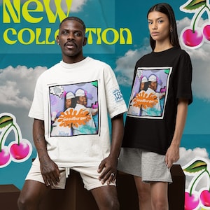 May include: Two people wearing t-shirts with a graphic print of a cartoon image of two people with the text "Goodburger" on the shirts. The person on the left is wearing a white t-shirt and beige shorts. The person on the right is wearing a black t-shirt and gray shorts. Both people are wearing white socks and sneakers.