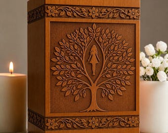 May include: A rectangular wooden cremation urn featuring a carved tree of life motif on the front panel. The center of the tree includes a silhouette of a person. The top and bottom borders are decorated with a carved floral vine pattern.